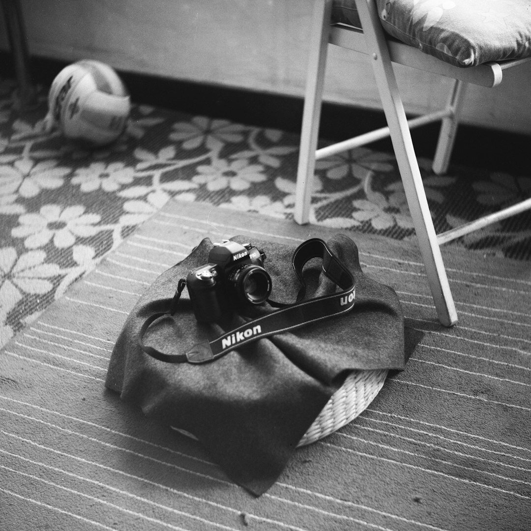 Professional camera body and lenses arranged on a table for a training workshop