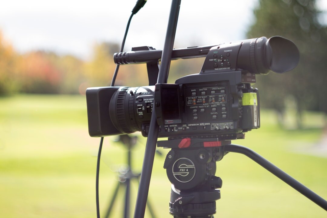 Broadcast video camera on a tripod set up for a live news report