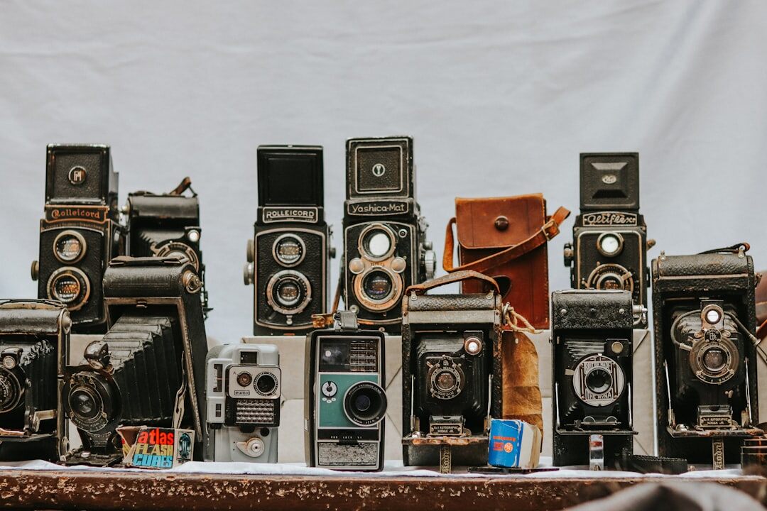 Vintage and modern cameras displayed together representing the evolution of photojournalism
